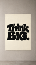 Chunky black Think BIG. lettering on a plain cream background, poster on a plain wall