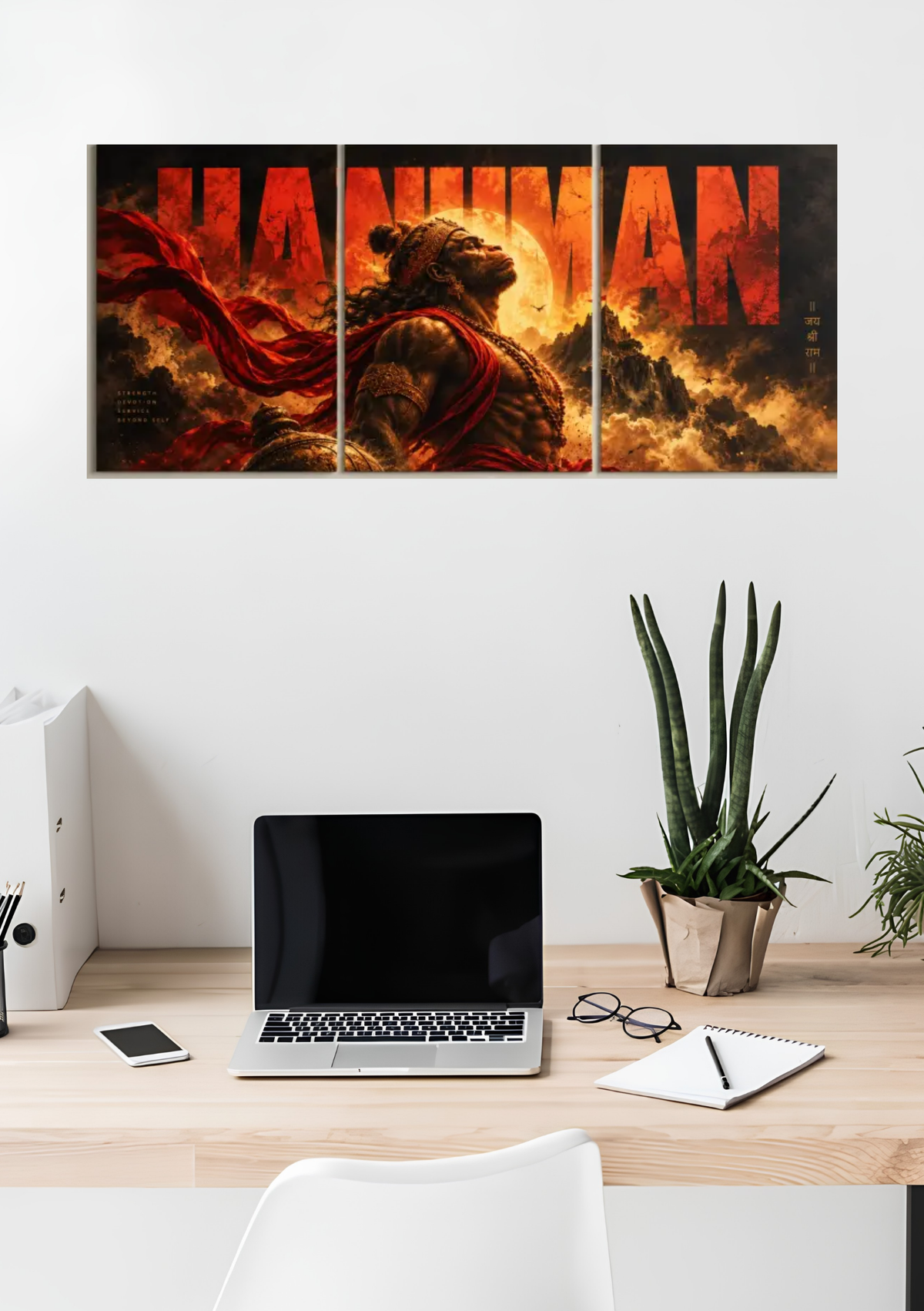 Hanuman in red and orange flames across three panels with large HANUMAN lettering, 3 piece split poster above a desk