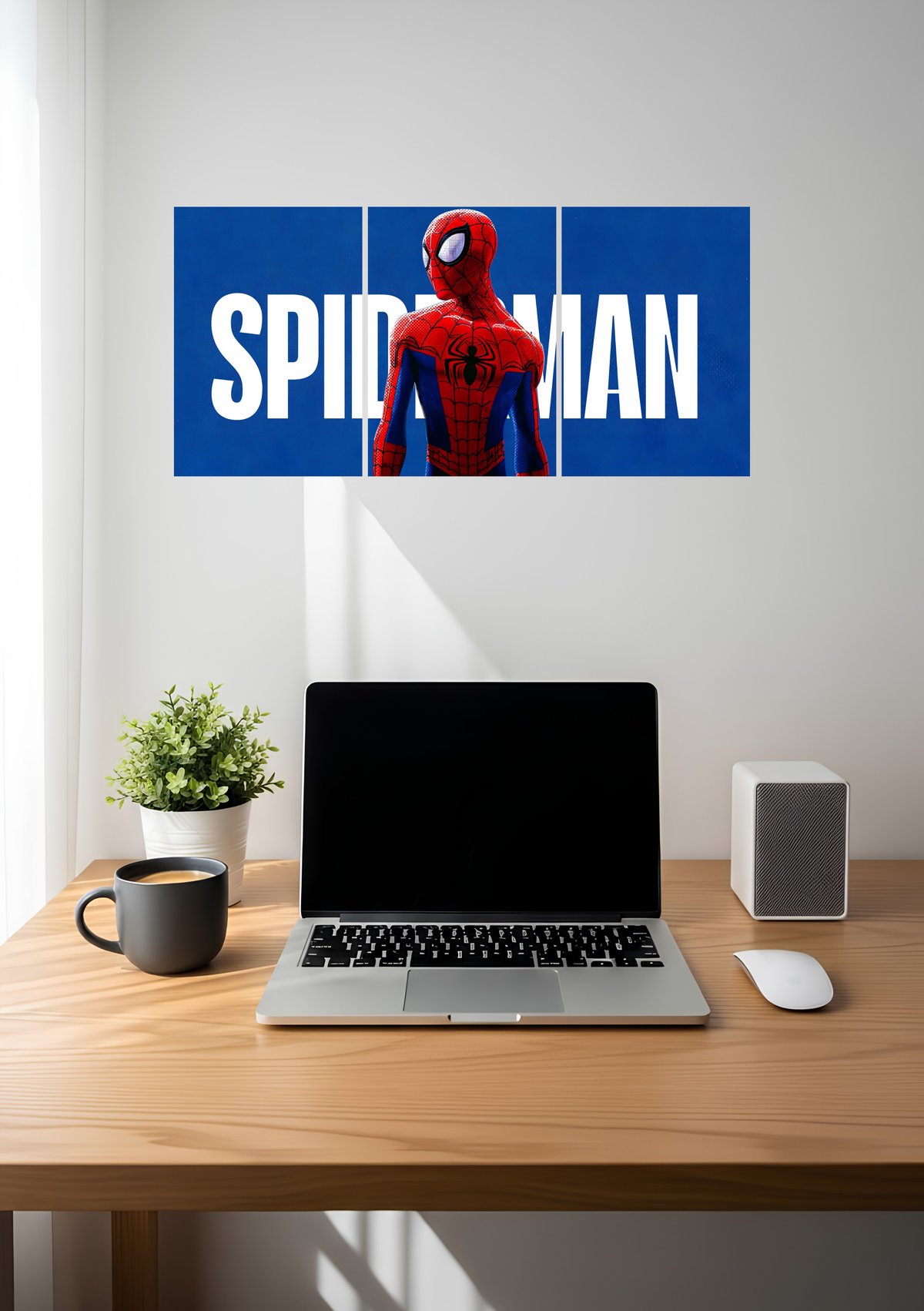 A red and blue masked hero in front of big white lettering on royal blue, across three panels, 3 piece split poster above a desk